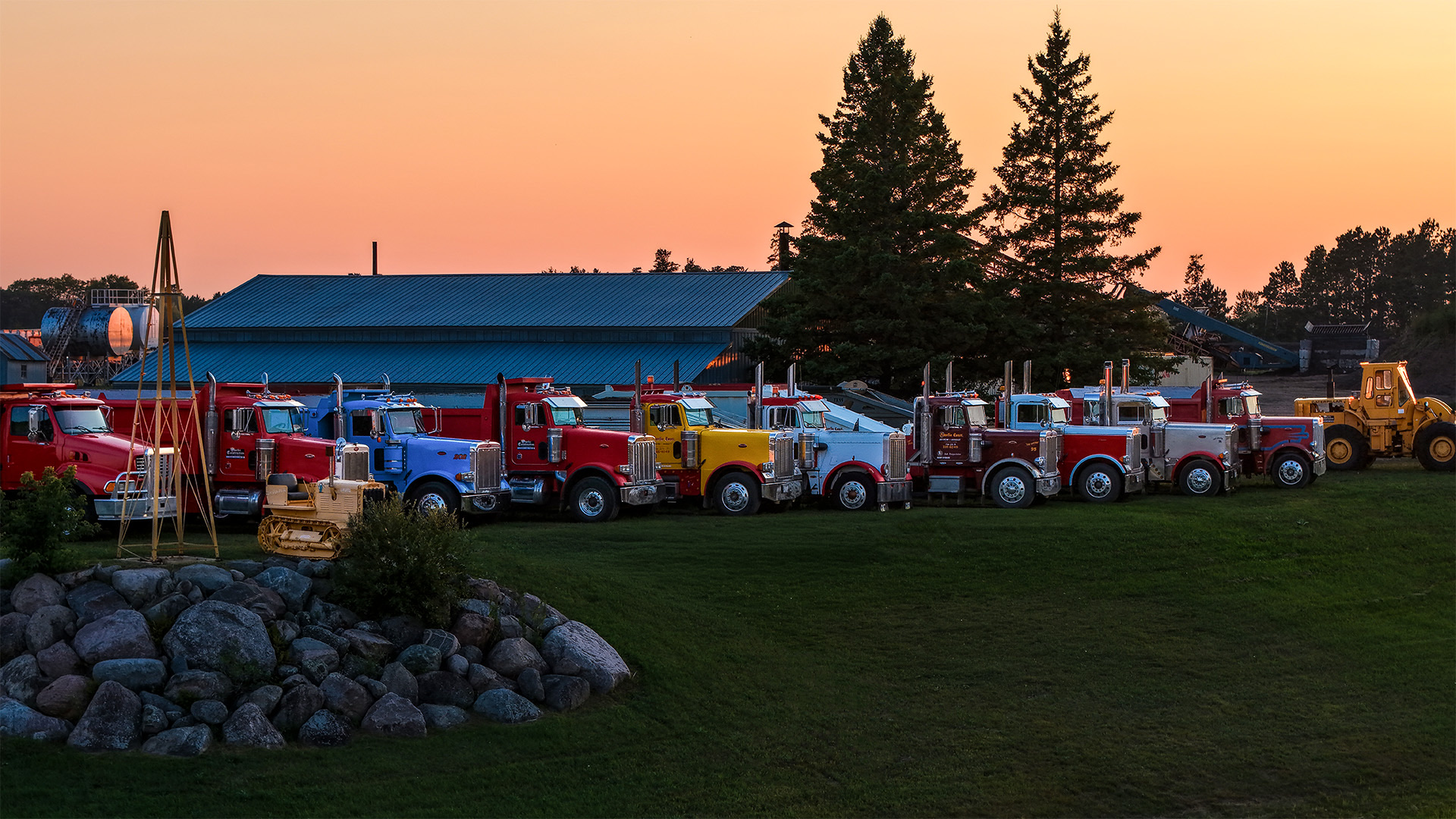 Storlie dump trucks and heavy equipment lined up at the Highway 2 yard