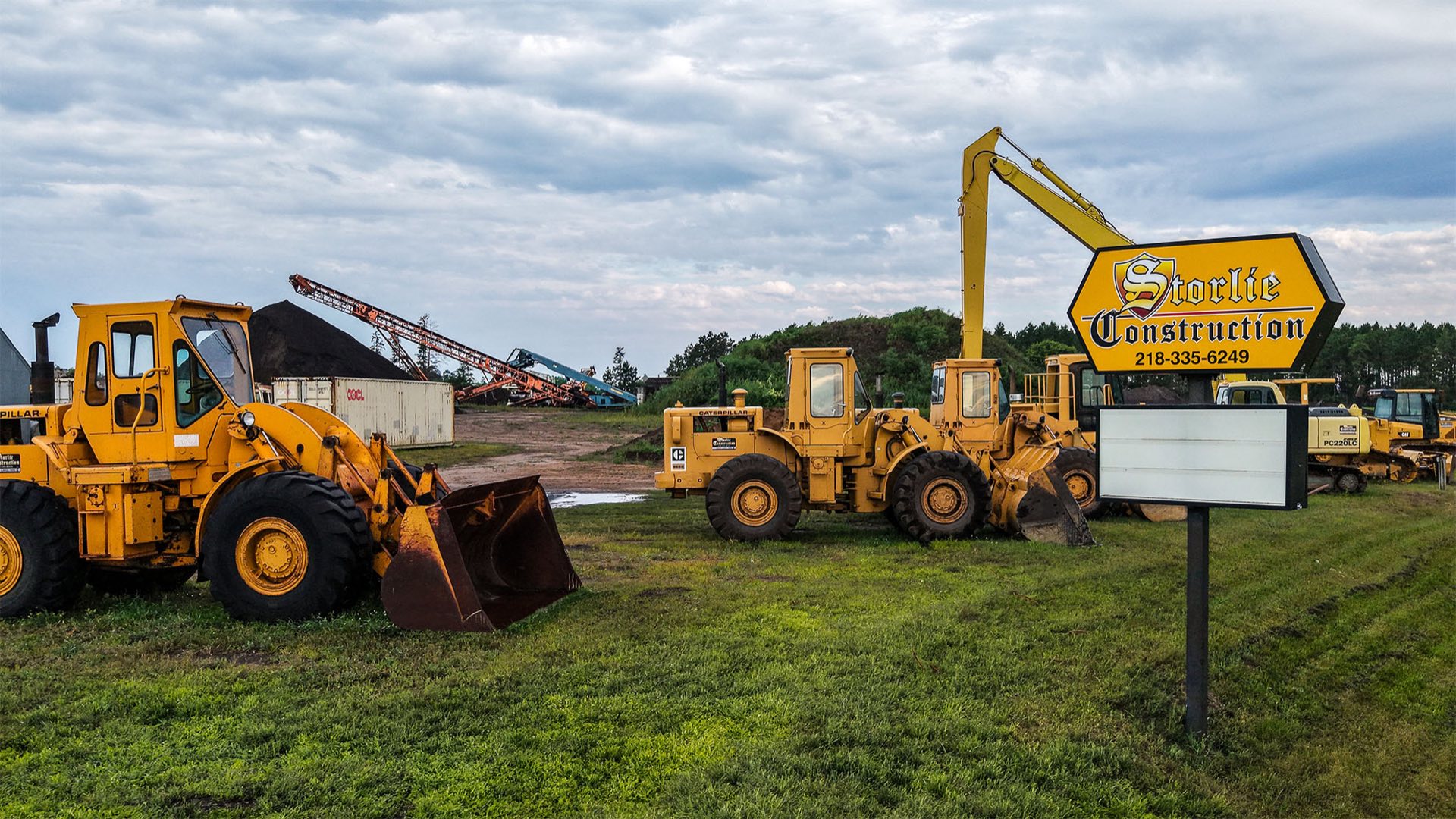 Full lineup of Storlie trucks and equipment at the Highway 2 yard