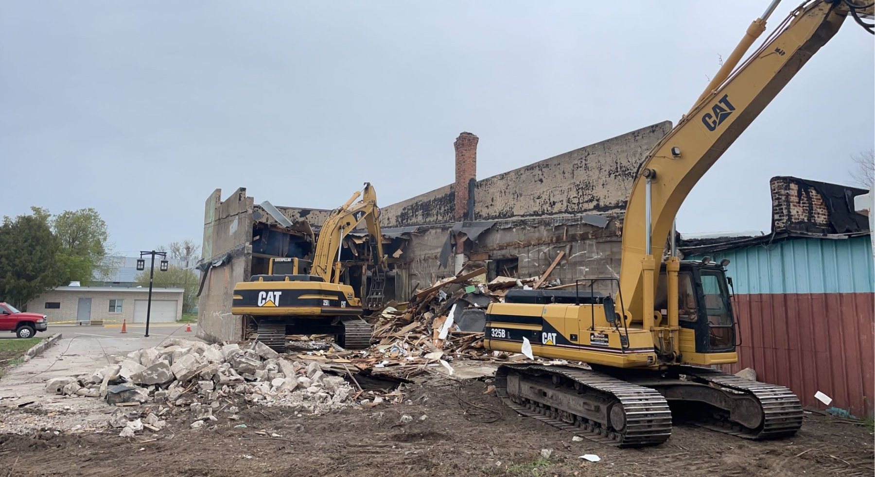 Two Storlie excavators working through a demolition site