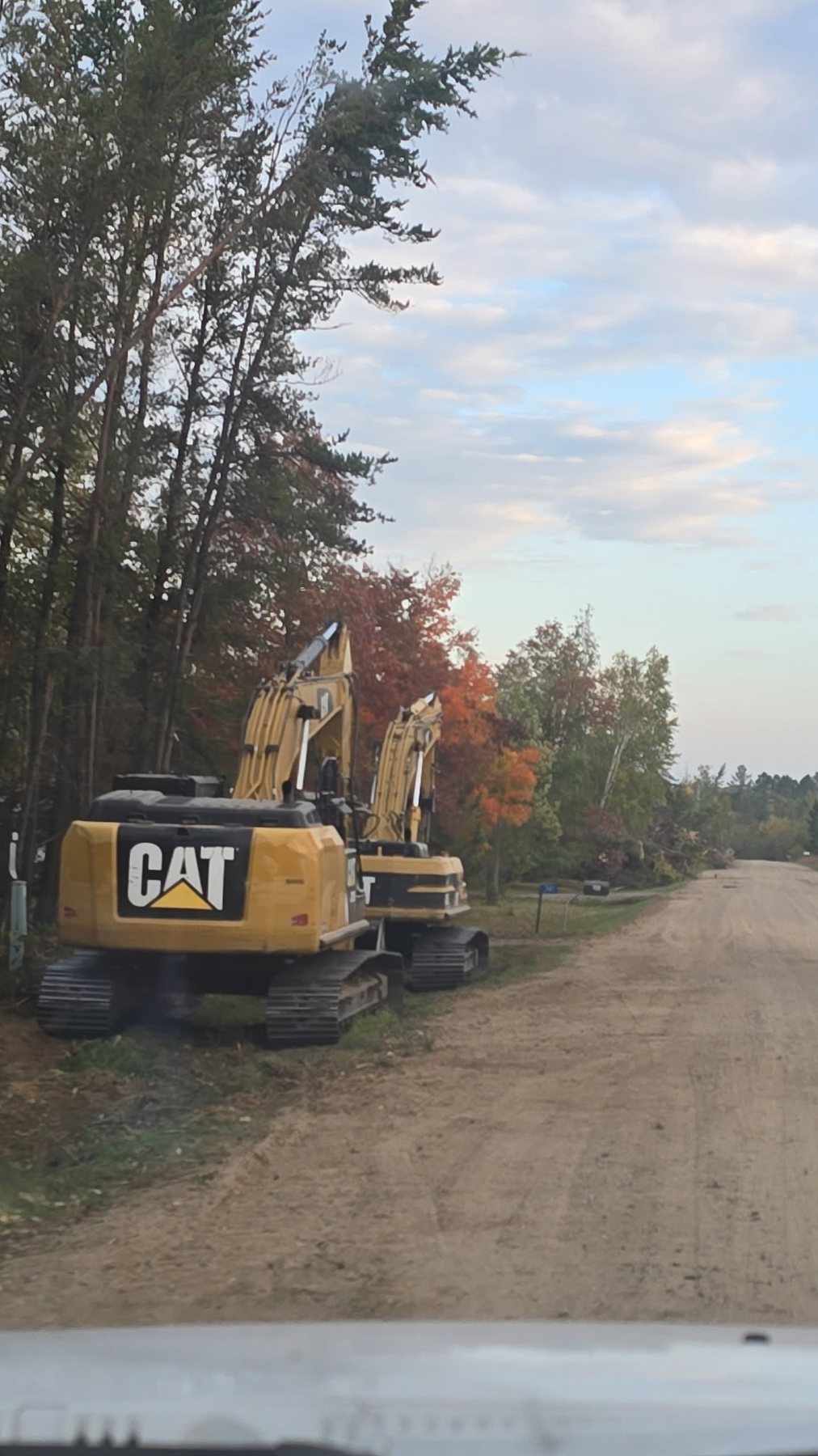 Multiple excavators working along a road construction project