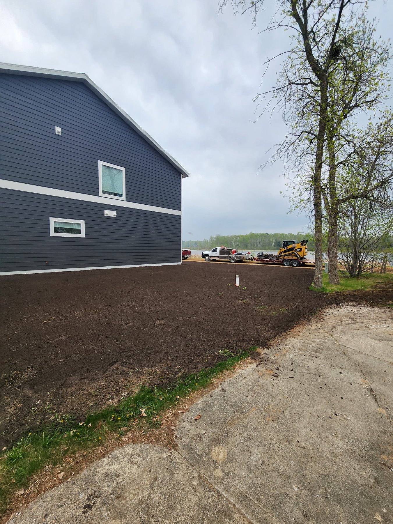 Finish grading around a completed lake-country home