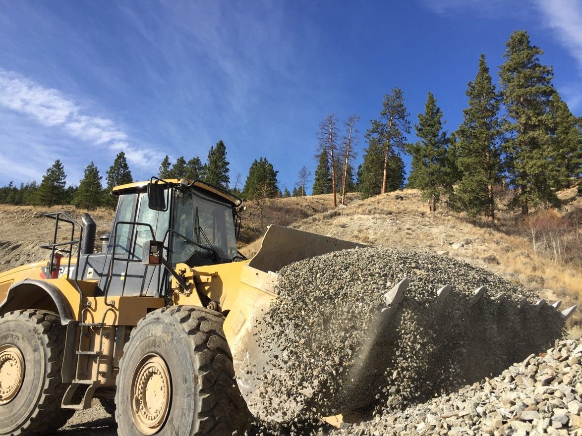 Front-end loader carrying a full bucket of gravel