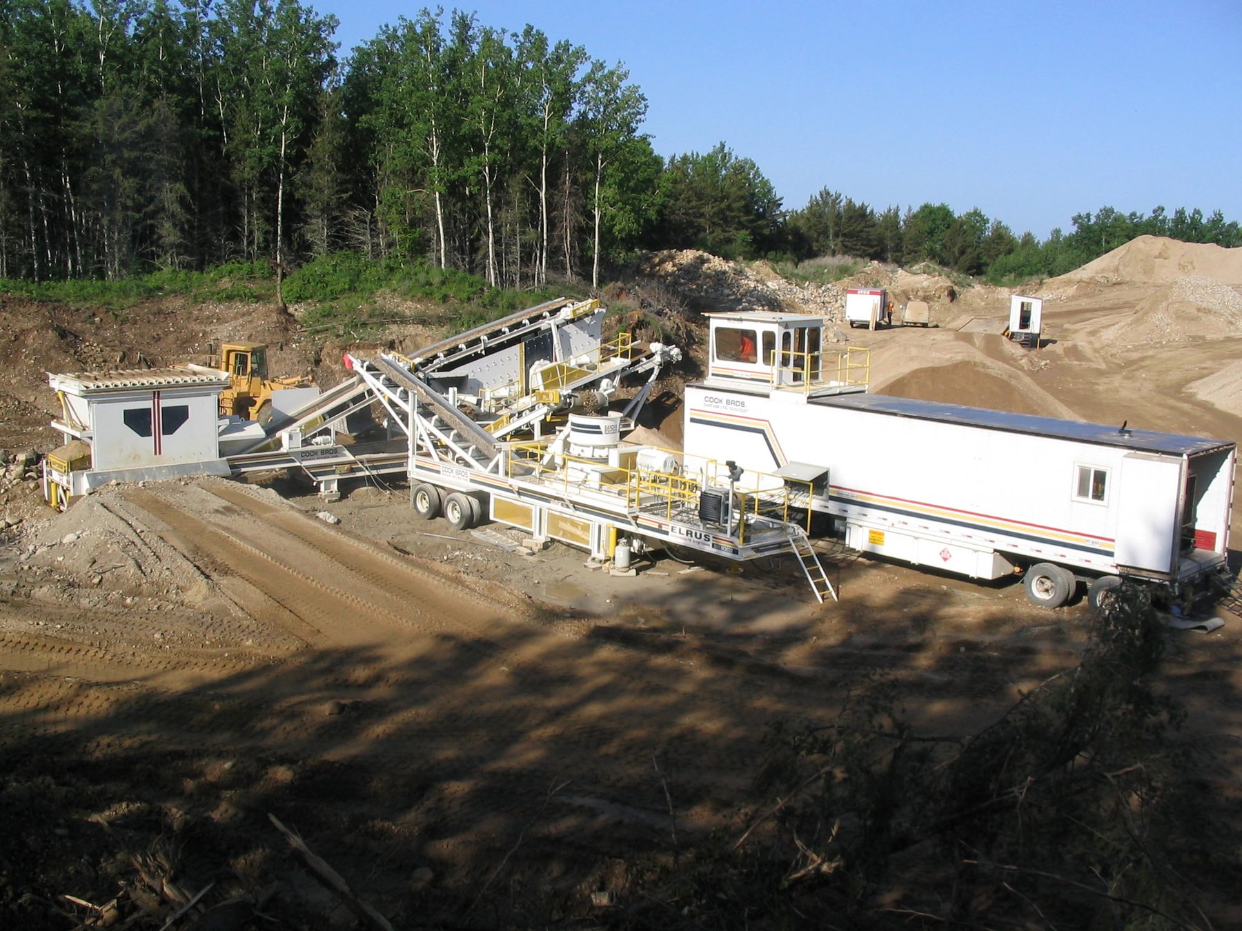 Wide view of aggregate-processing equipment and stockpiles