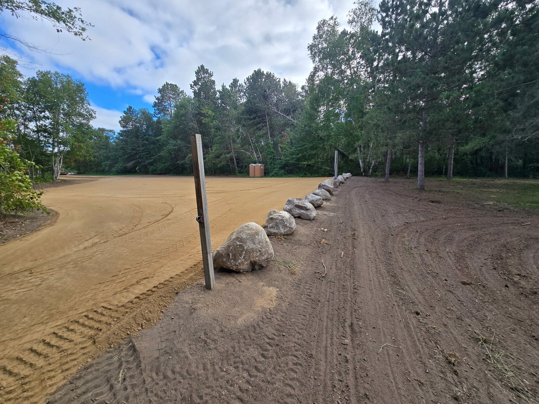 Graded access road bordered with large rip rap stone