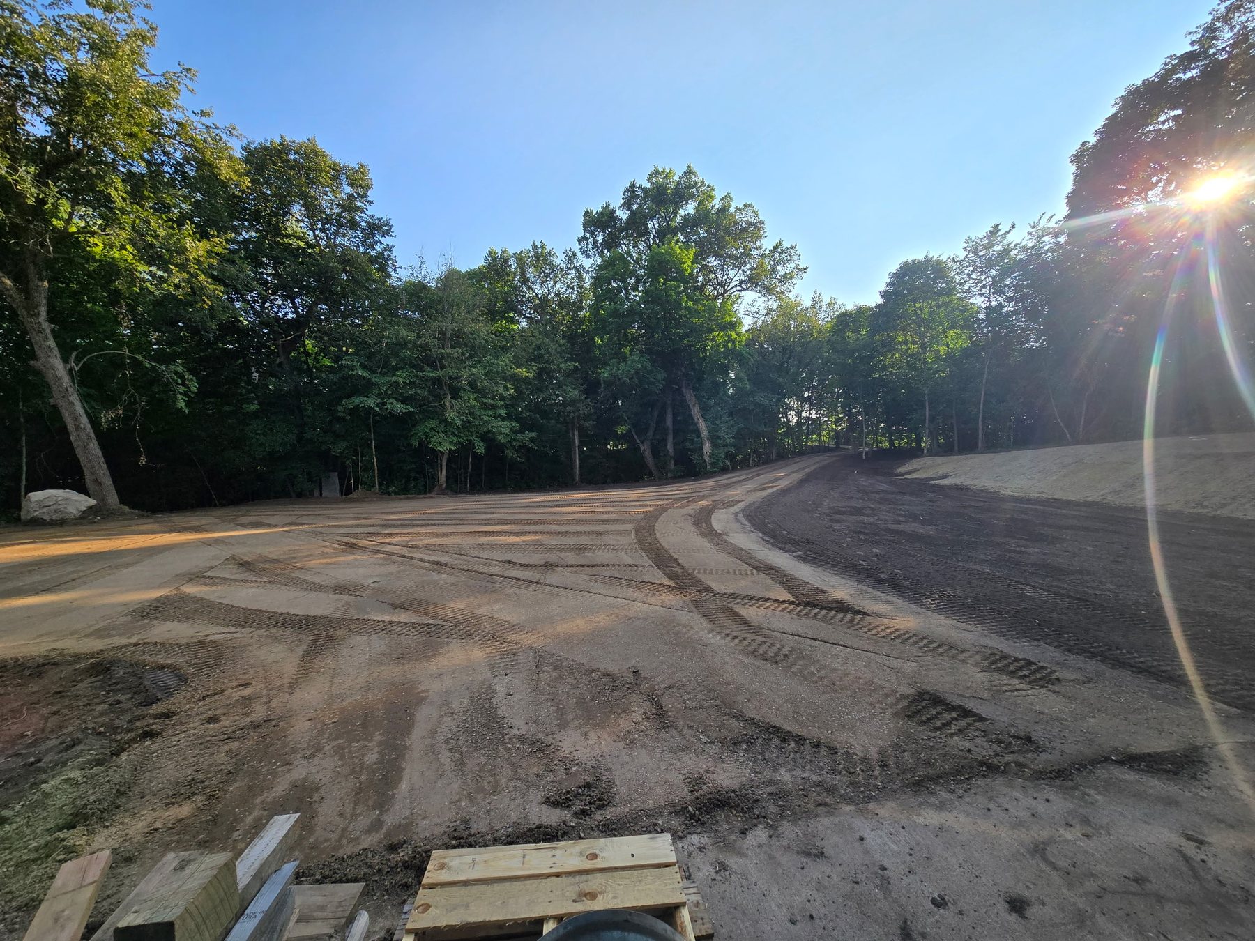 Freshly graded gravel road curving through a Northern Minnesota property
