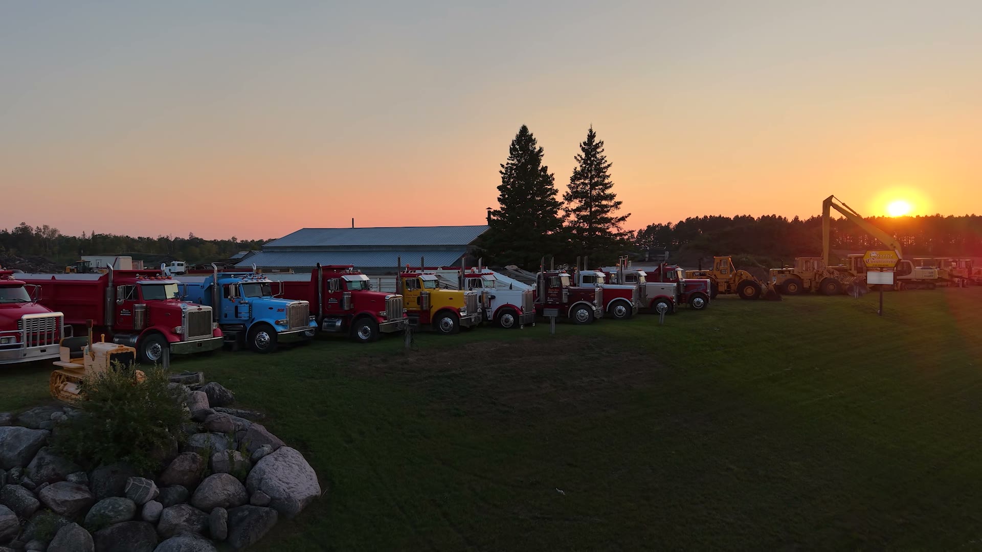 Aerial view of Storlie Construction's gravel pit and equipment yard at sunset