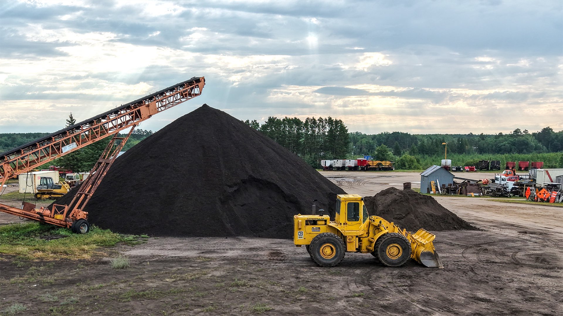 Wheel loader moving topsoil at the Storlie pit